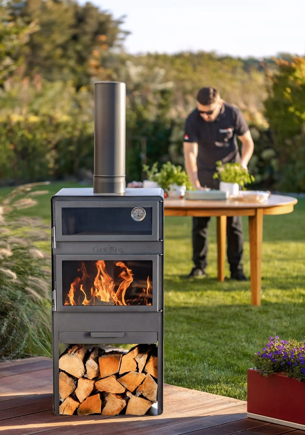 Outdoor oven with firewood storage on a garden terrace